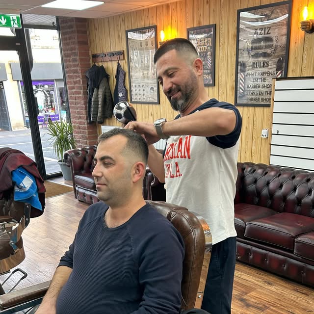 A barber working on a client's haircut, from Ali's Instagram